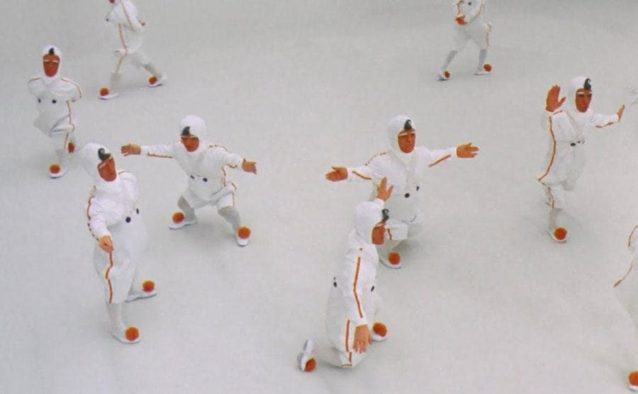 Oompa Loompas doing cartwheels in an all white room 