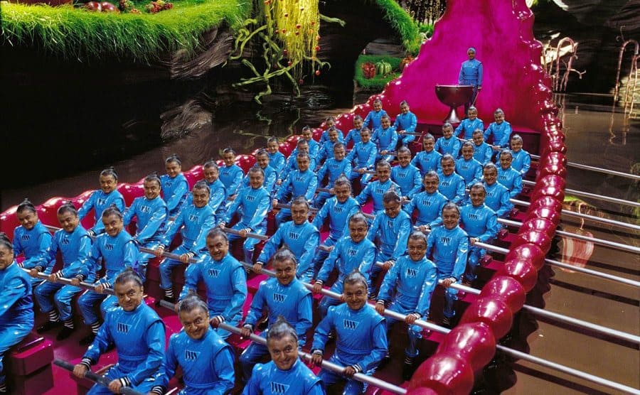 Deep Roy as the Oompa Loompa multiplied so that he is taking up every row of seats in a boat