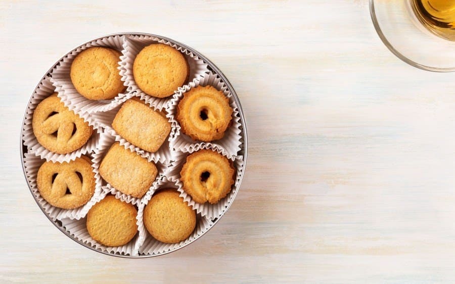 Overhead view of Danish butter cookies with tea and copy space