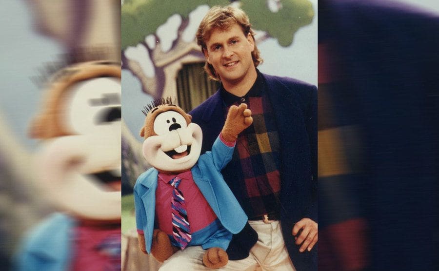 Dave Coulier as Joey Gladstone holding his puppet for a promotional photoshoot for Full House 