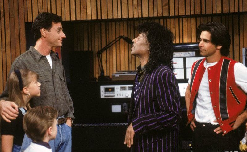 Little Richard with Danny, Stephanie, and Jesse standing around the piano in the basement 