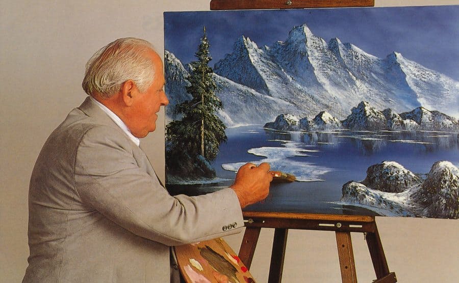 William Alexander is working on a painting. 