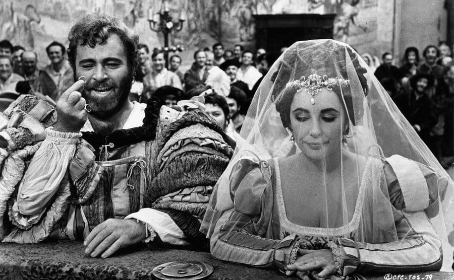 Richard Burton holding ring next to Elizabeth Taylor in a scene from the film 'The Taming Of The Shrew,' 1967.