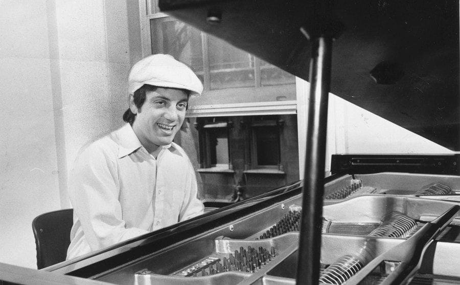 Musician Billy Joel plays piano in his Manhattan apartment on May 28, 1976.