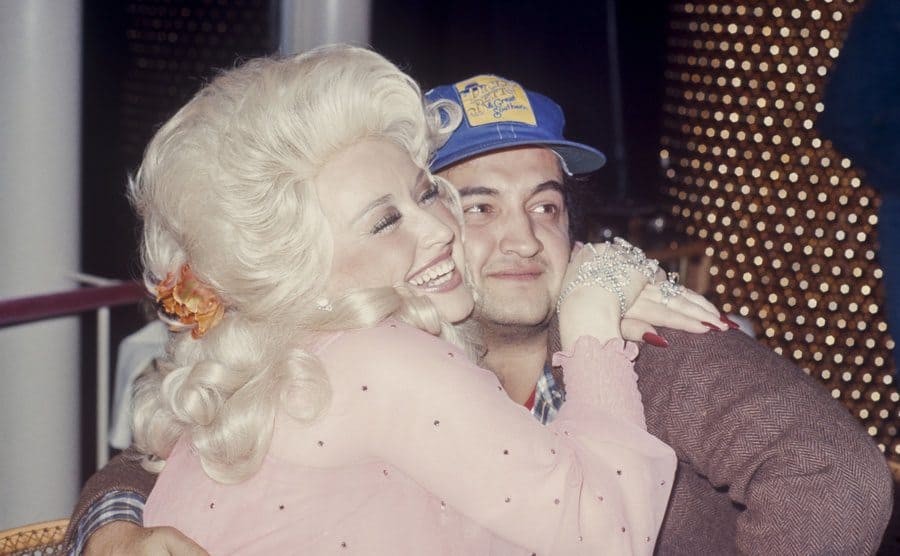 Dolly Parton hugging John Belushi 