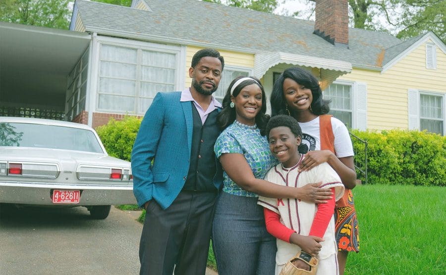 Dulé Hill, Laura Kariuki, Saycon Sengbloh, and Elisha Williams pose outside their home in a promotional photo for The Wonder Years reboot. 