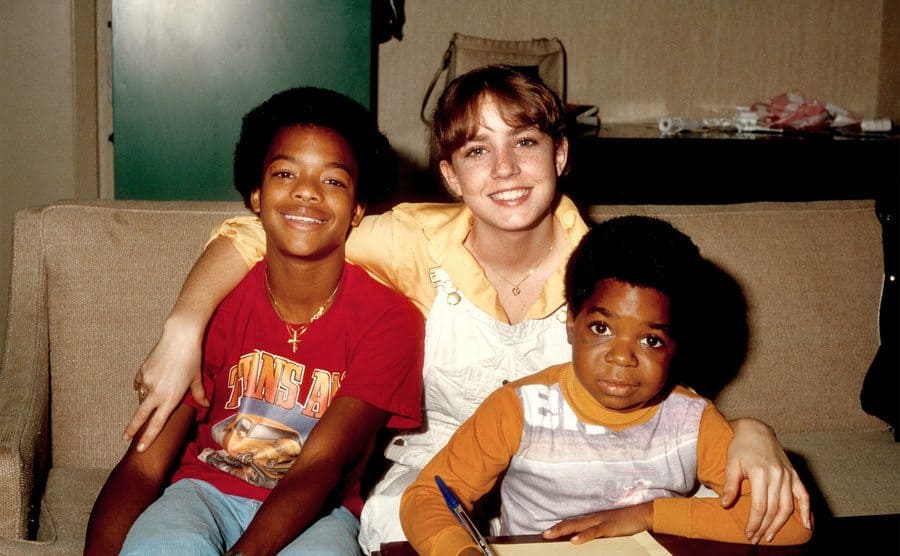 Gary Coleman poses for a portrait with co-stars Dana Plato and Todd Bridges while studying on the set of his show 'Diff'rent Strokes'.