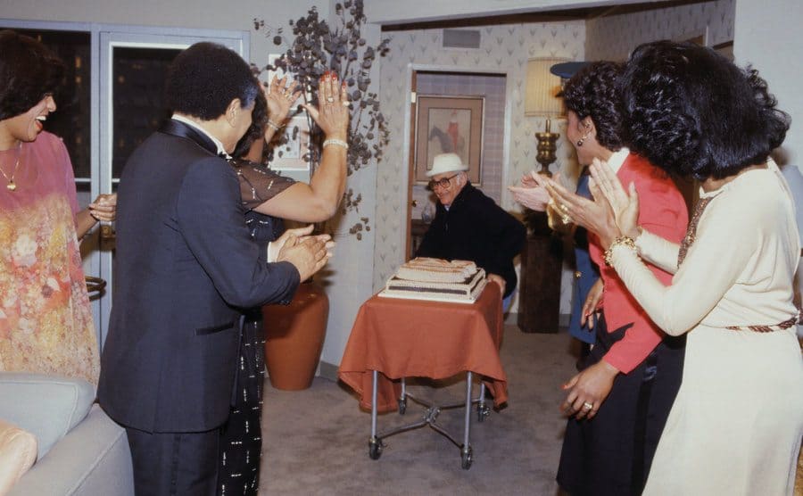 Producer Norman Lear joins the cast of The Jeffersons, bringing a cake to the room as they celebrate the taping of the 200th episode of the hit series.