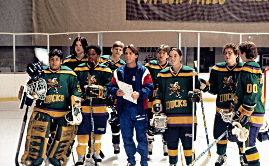 Coach Bombay walks on to the ice with his players, in a still from ‘The Mighty Ducks’