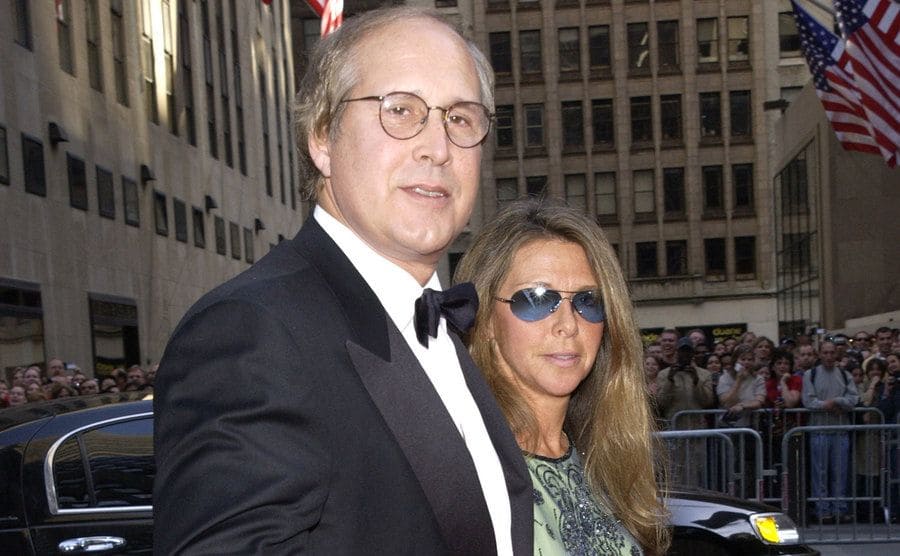Chevy Chase and his wife are walking the red carpet at an NBC event. 