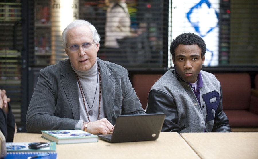 Chevy Chase and Donald Glover sitting together in a still from the show.