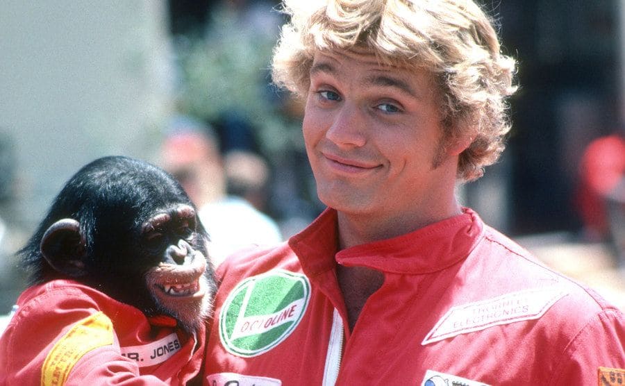 John Schneider is holding a monkey on the set of The Dukes of Hazzard. 
