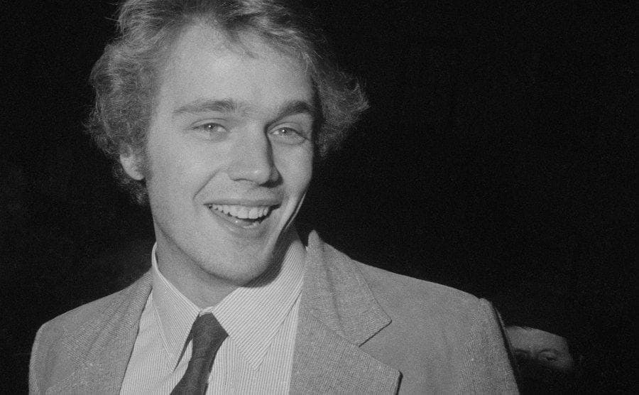 Close-up of John Schneider smiling, circa 1970.