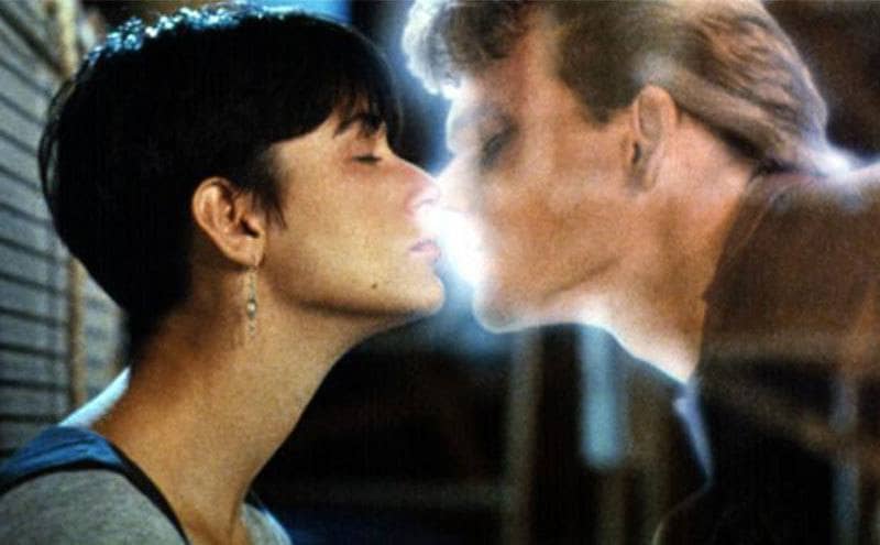 Movie still where Patrick Swayze’s ghost is about to kiss Demi Moore.