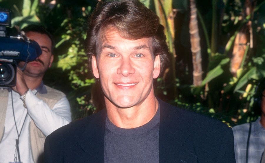 Patrick Swayze is posing for the press.