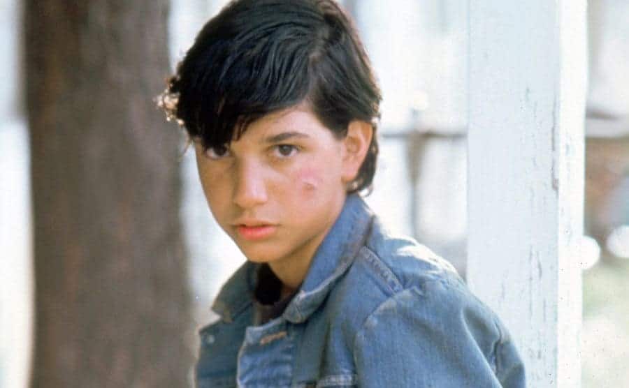 Ralph Macchio is posing for a publicity shot on the set of The Outsiders.
