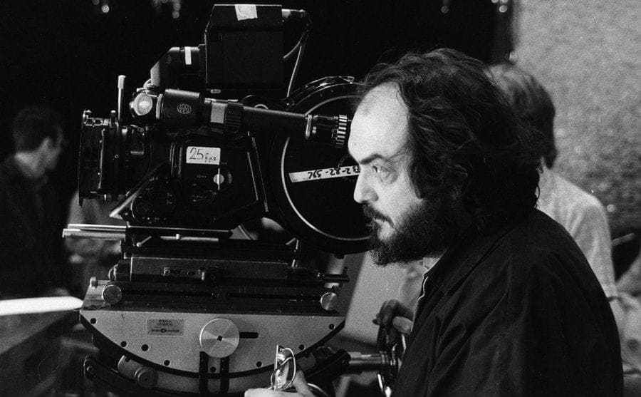 Stanley Kubrick behind the camera filming on set. 