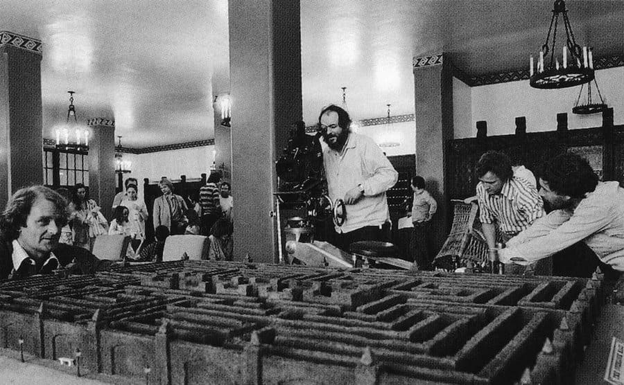 Kubrick films as he stands over a miniature model of the maze. 
