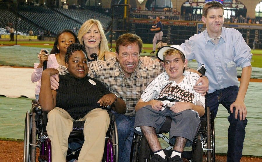 Chuck Norris and his wife pose with four children at the Make-A-Wish Foundation event.