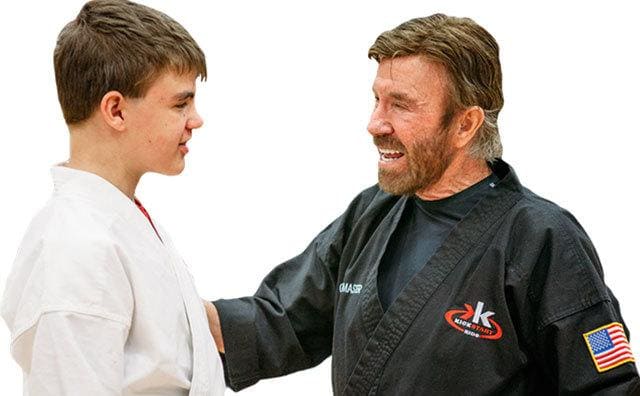Chuck Norris talks to a kid from the Kick Start Kids foundation. 