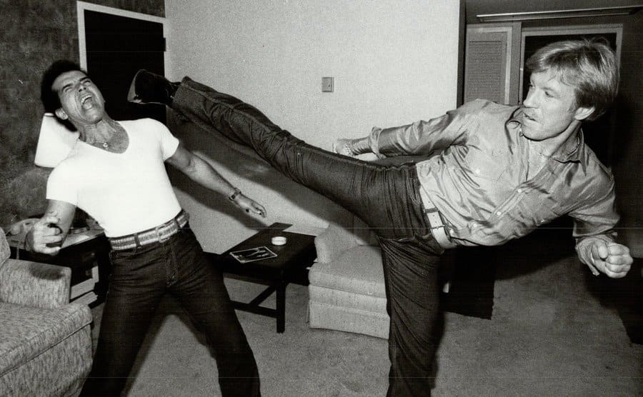 Chuck Norris gives a kick as he wears his line of jeans.