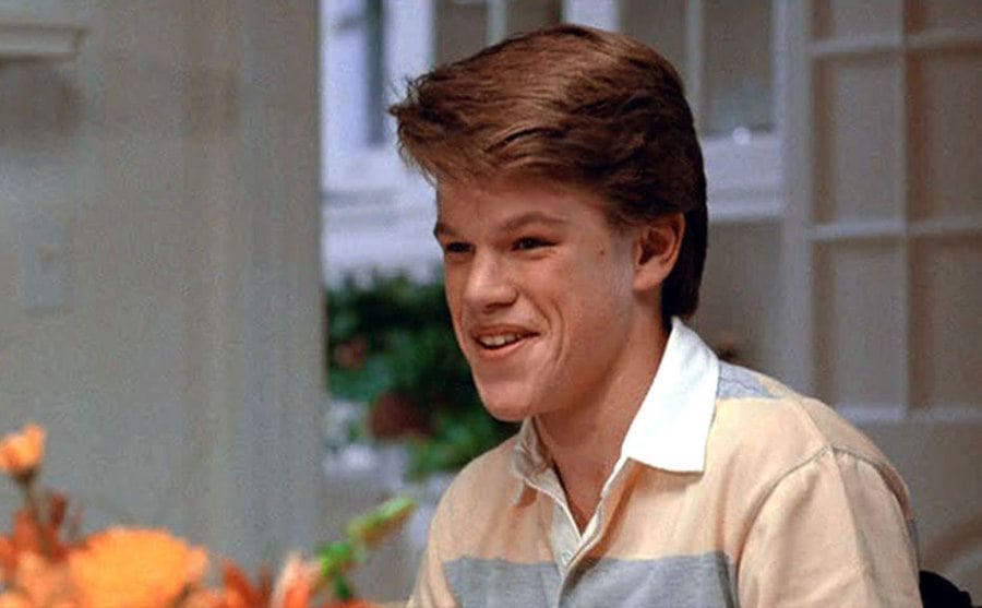 Matt Damon sits at the dinner table in a still from Mystic Pizza. 