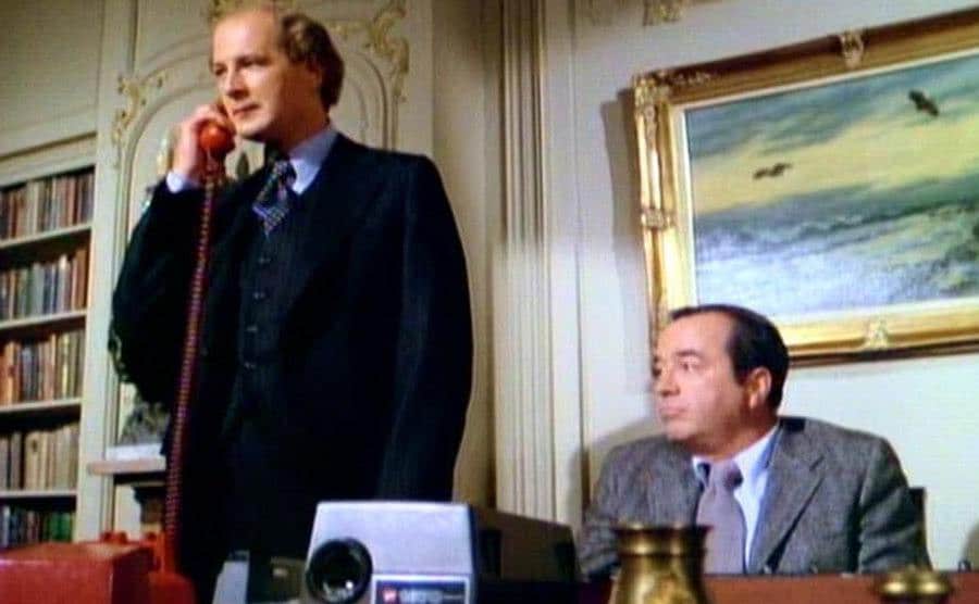 A still from a scene featuring David Ogden Stiers and David Doyle. 
