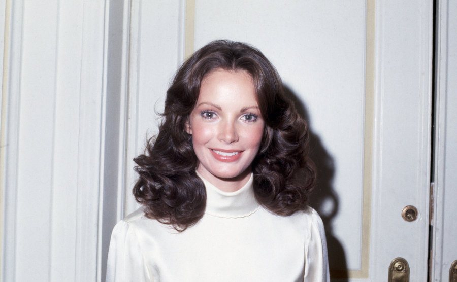 Jaclyn Smith is smiling at the camera. 