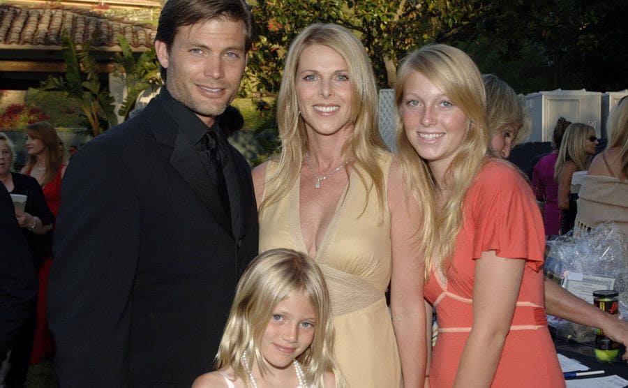 Catherine poses next to her husband and daughters at an event. 