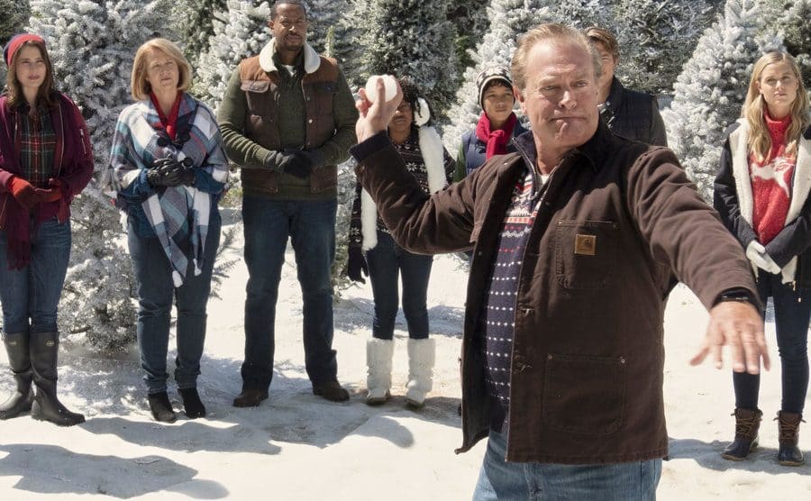 John James throws a snowball in a still from the movie ‘Christmas Camp.’