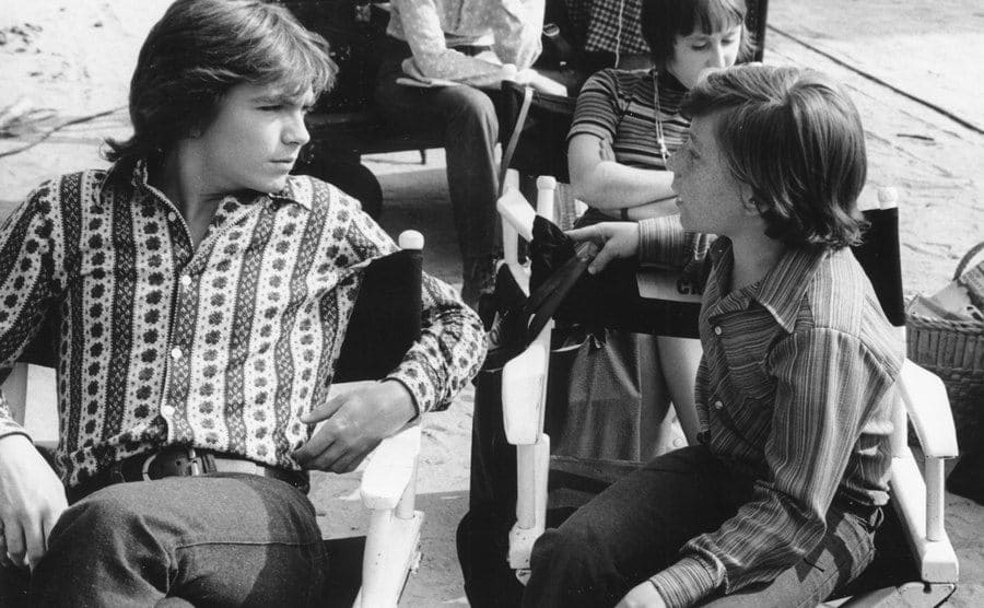 Danny Bonaduce speaks to David Cassidy during filming. 