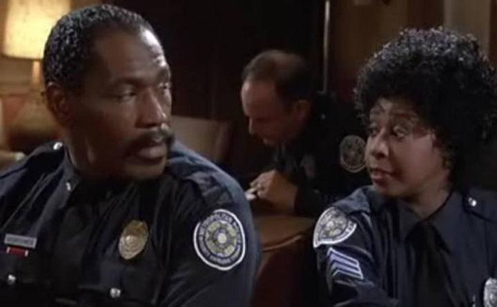 Bubba Smith and Marion Ramsey glancing at each other. 