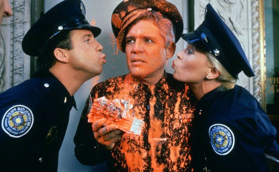Lance Kinsey and Leslie Easterbrook give G.W. Bailey a kiss on the cheek. 