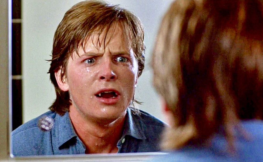 Michael J. Fox looking at himself in the mirror in Teen Wolf.