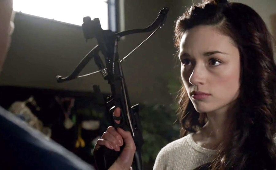 Allison Argent holding a bow and arrow.