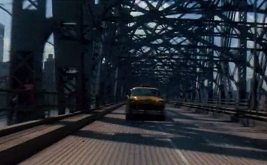 The taxicab from the opening credits driving over a bridge. 