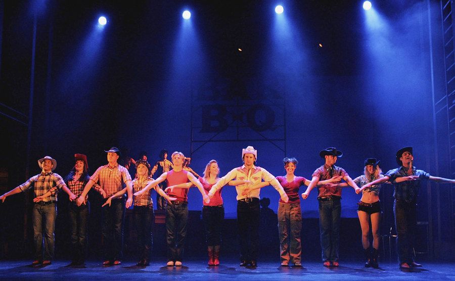 The cast from Footloose: The Musical on stage.