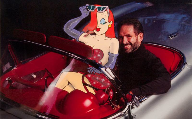 Gary Wolf sits in a convertible car with his arm around a cartoon Jessica Rabbit. 