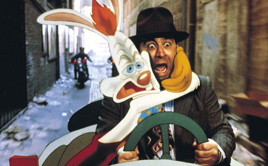 A terrified Eddie Valiant and Roger Rabbit are about to crash a cartoon car. 