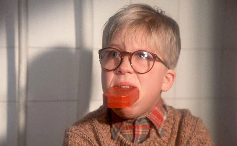 Ralphie sits in the bathroom with a bar of soap in his mouth. 