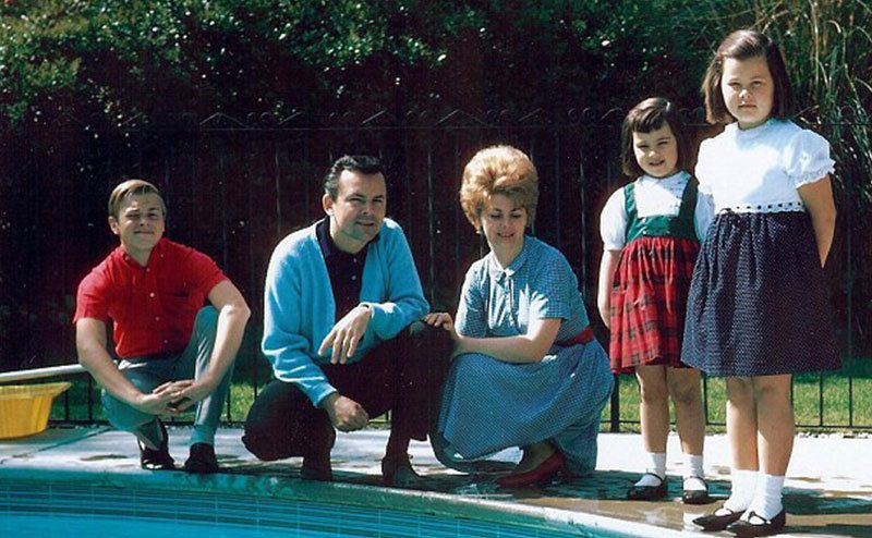 A dated picture of the Crane’s family posing by the pool.