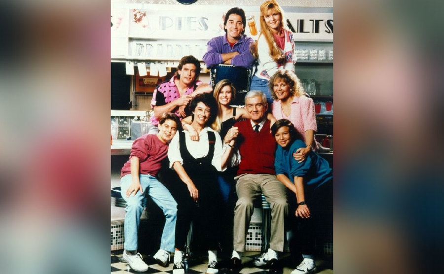 The cast of Charles in Charge poses together on set. 