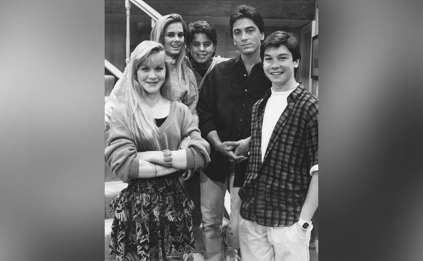 Scott Baio poses with his younger cast members on set. 