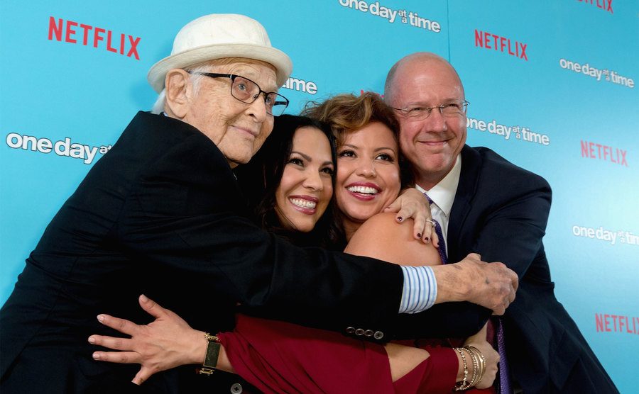 Norman Lear, Gloria Calderon Kellett, Justina Machado, and Mike Royce embrace the red carpet. 