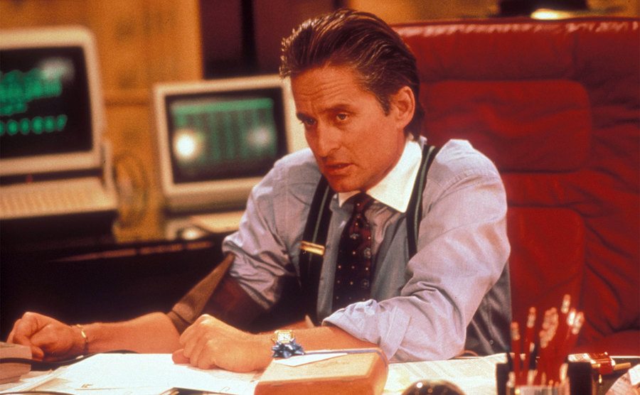 Michael Douglas, as Gordon Gekko, sits in his office in a still from Wall Street. 
