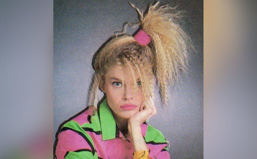A woman poses with her crazy crimped hair. 