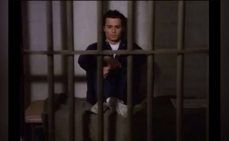 Depp as Hanson sits behind bars. 