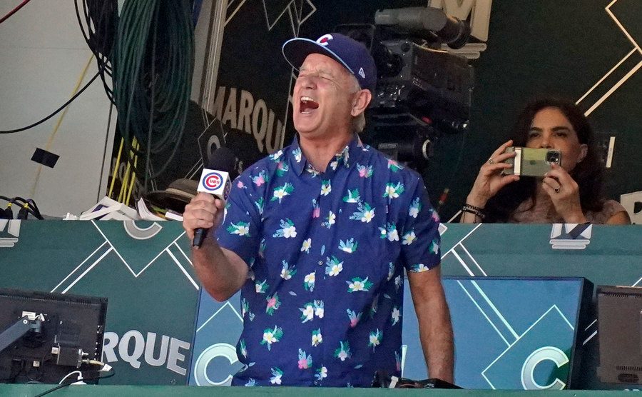 Bill Murray sings during the seventh inning of a game.