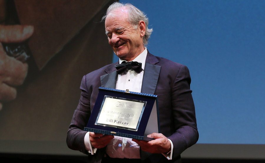 An image of Murray receiving an award on stage.