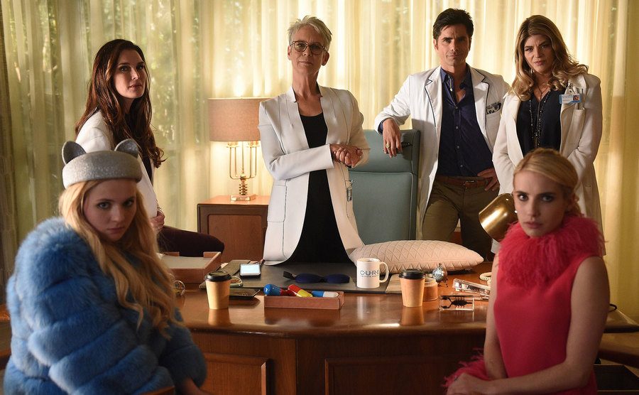 A photo of Abigail Breslin, Brooke Shields, Jamie Lee Curtis, John Stamos, Kirstie Alley, and Emma Roberts in Scream Queens.